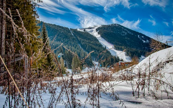 Breathtaking view of snowy mountains and ski resort in Bansko, Bulgaria.