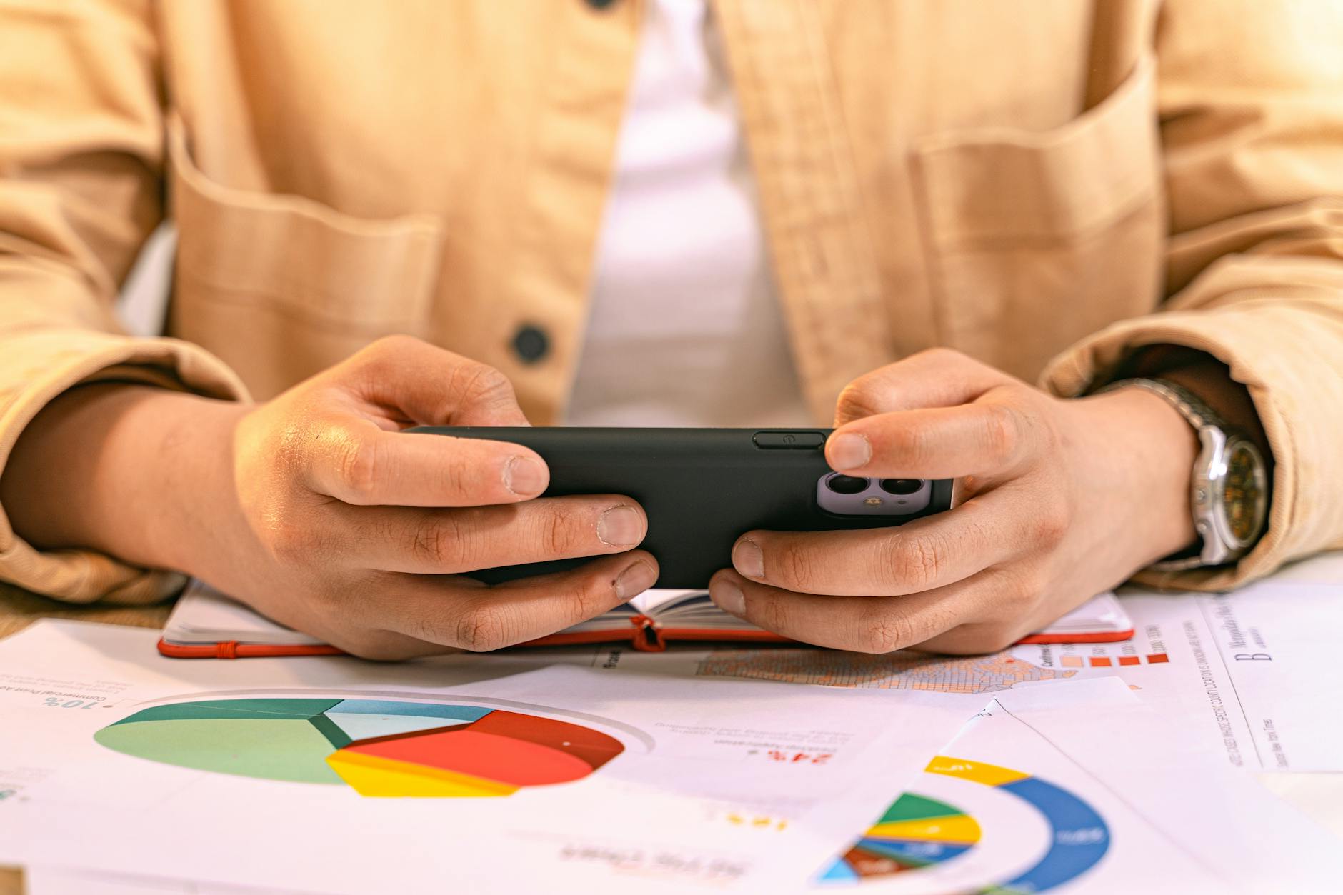 https://www.pexels.com/photo/woman-using-smart-phone-with-an-open-notebook-8374252/