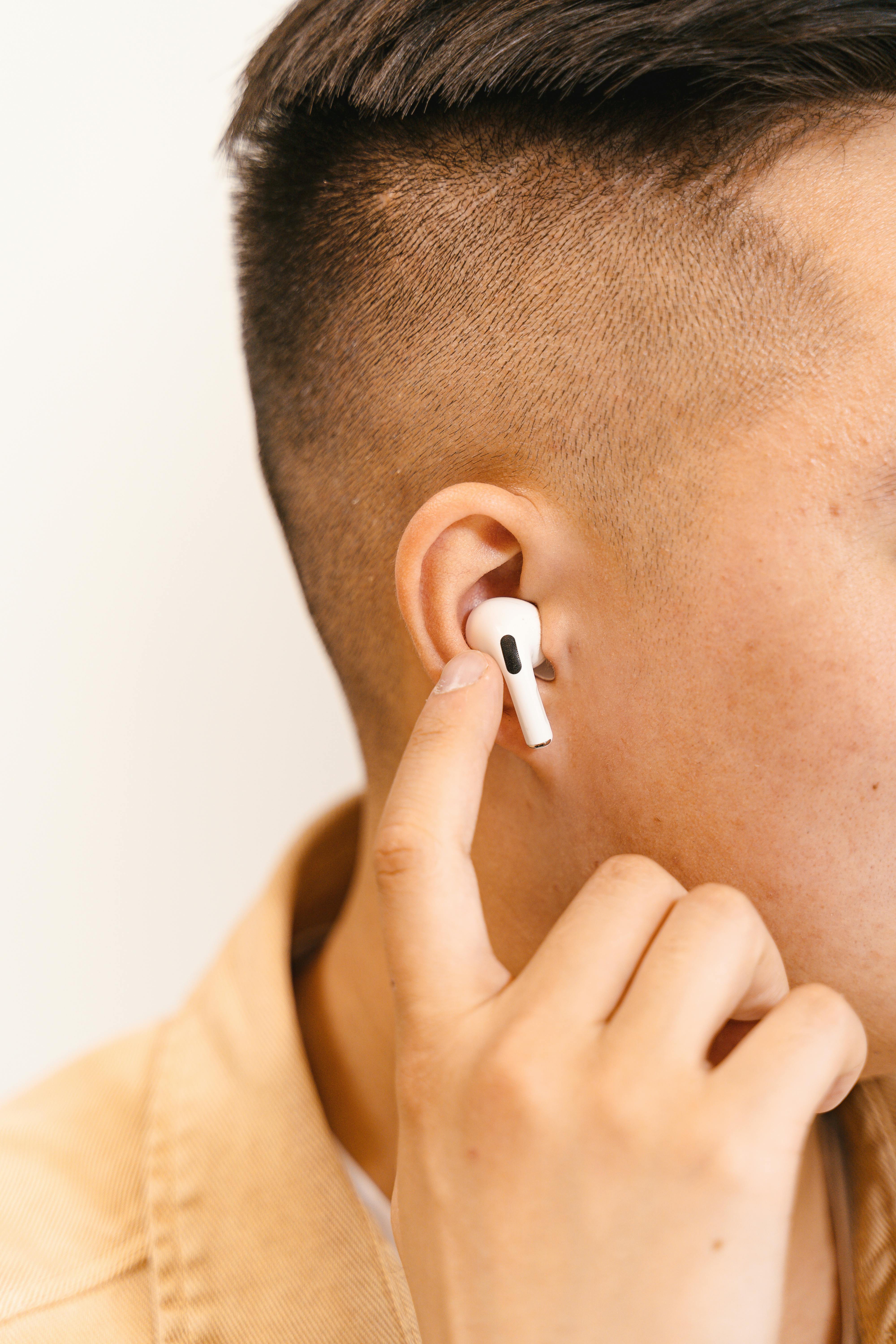 close up of man hand touching earphone