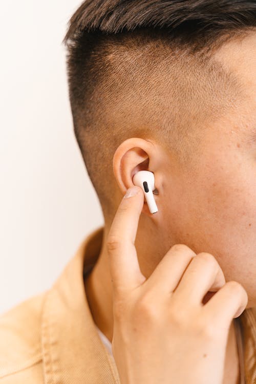 Close Up of Man Hand Touching Earphone 