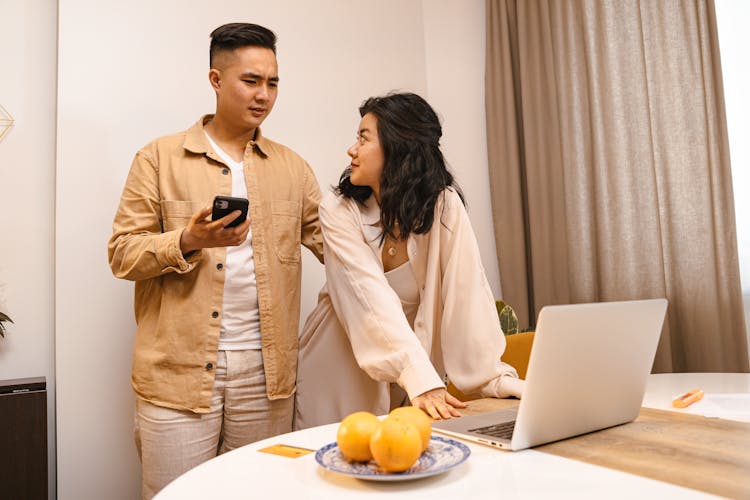 Couple Using Laptop At Home