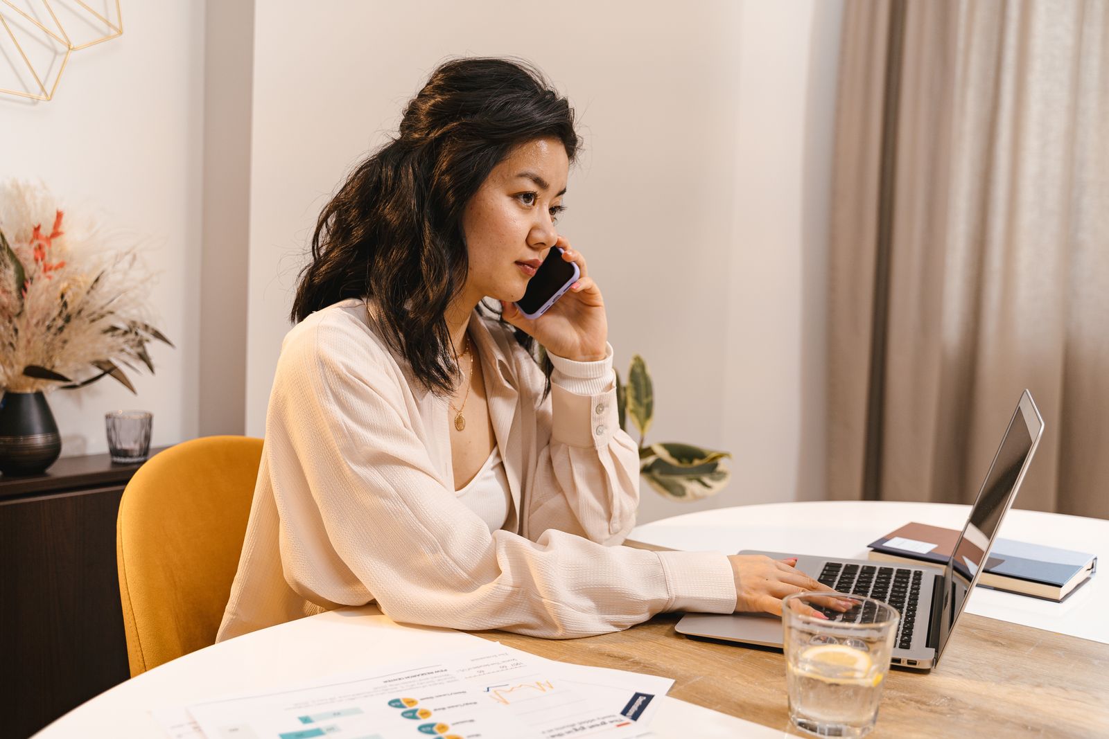 Digital entrepreneur working on a laptop and smartphone at a home office