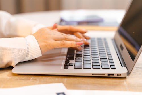 Free A Person Typing on Laptop Stock Photo