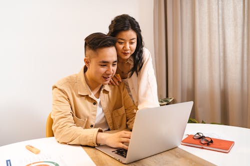 A Couple Using a Laptop