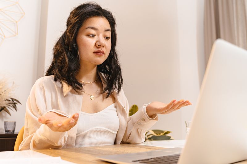 Small business owner looking overwhelmed by the complexity and numerous options of mobile applications, contemplating the necessity.
