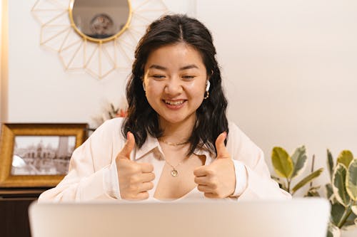 Free A Woman in a Video Call Doing a Thumbs Up Stock Photo