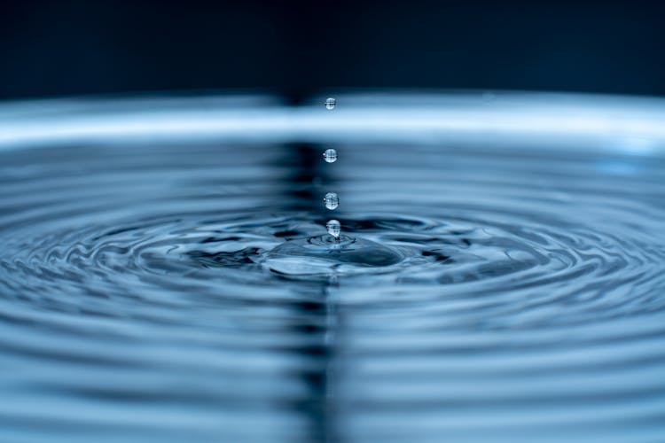 Droplets Creating Ripples On Water Surface