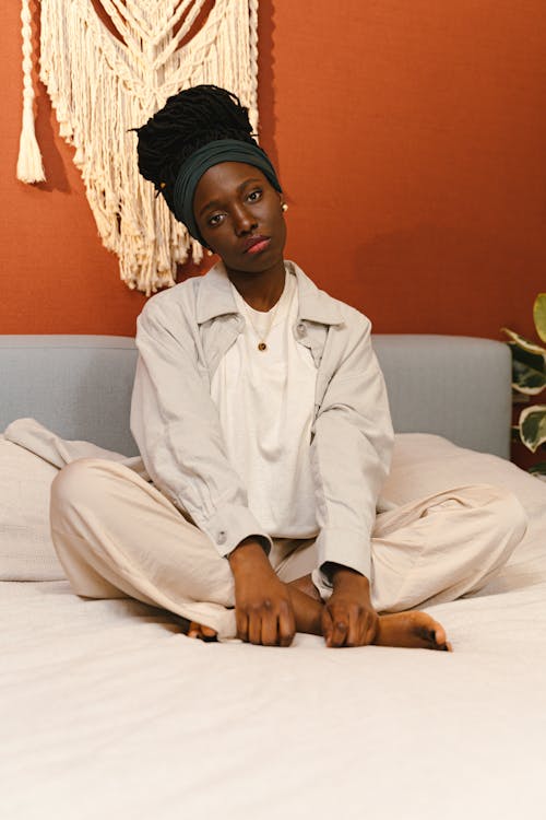 Woman Sitting Cross-Legged on Bed