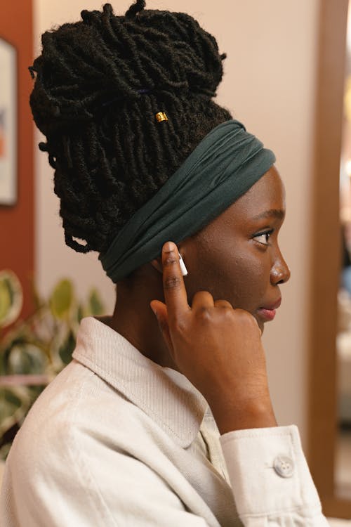 Free Woman Touching Wireless Earphone Stock Photo