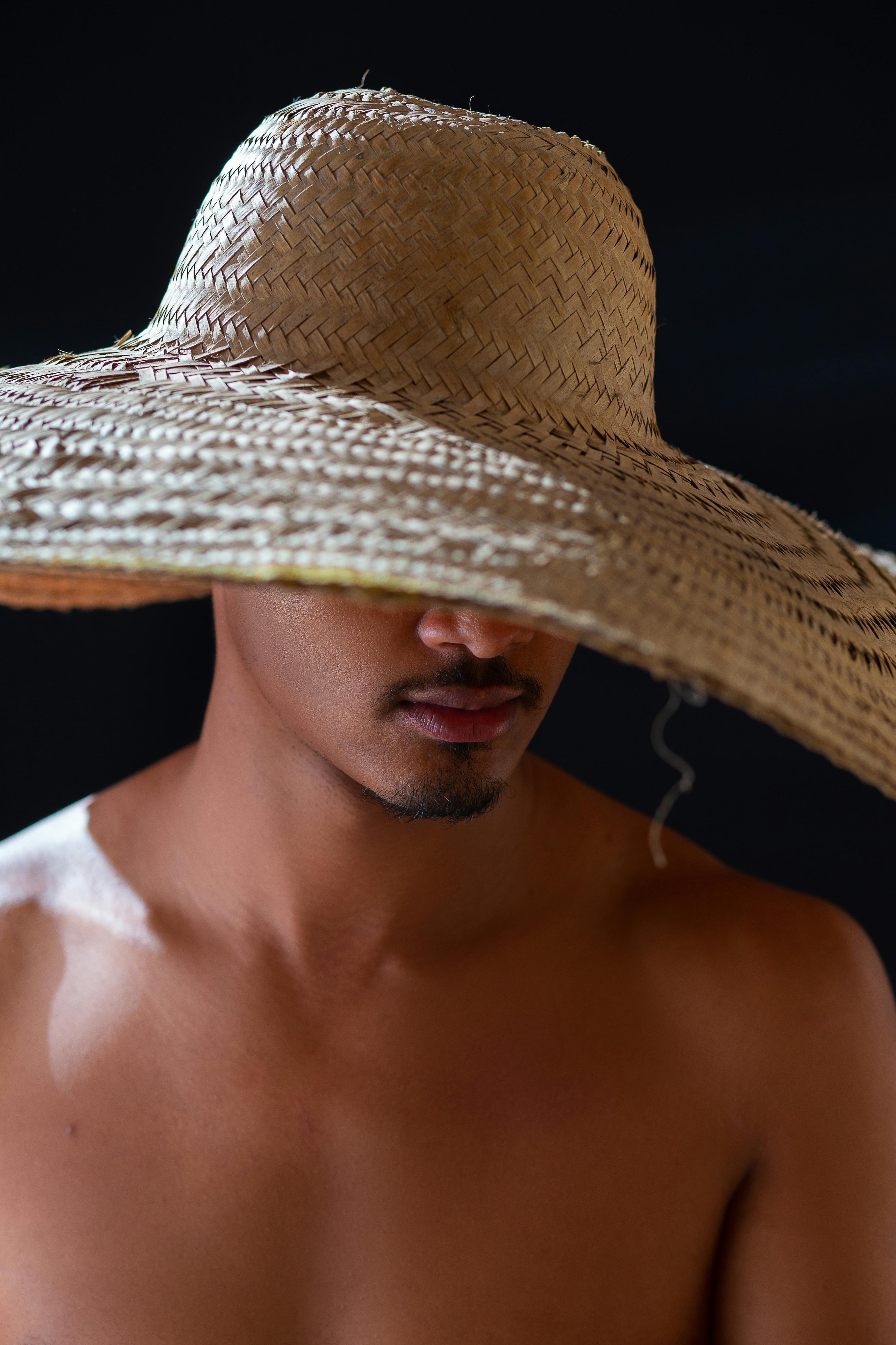 Person Holding Brown Woven Hat · Free Stock Photo