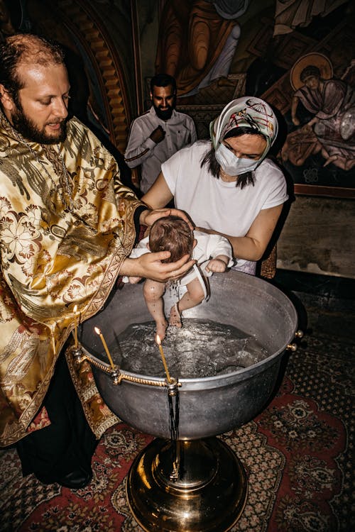 Priest Baptizing Newborn Child
