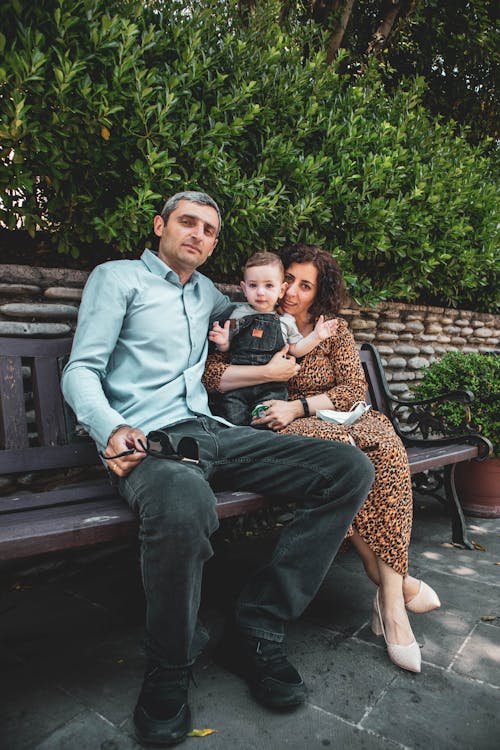 Happy Family Sitting on the Bench