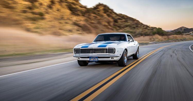 Blue And White Chevrolet Camaro On The Road