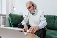 A Man in White Vest Taking His Meds