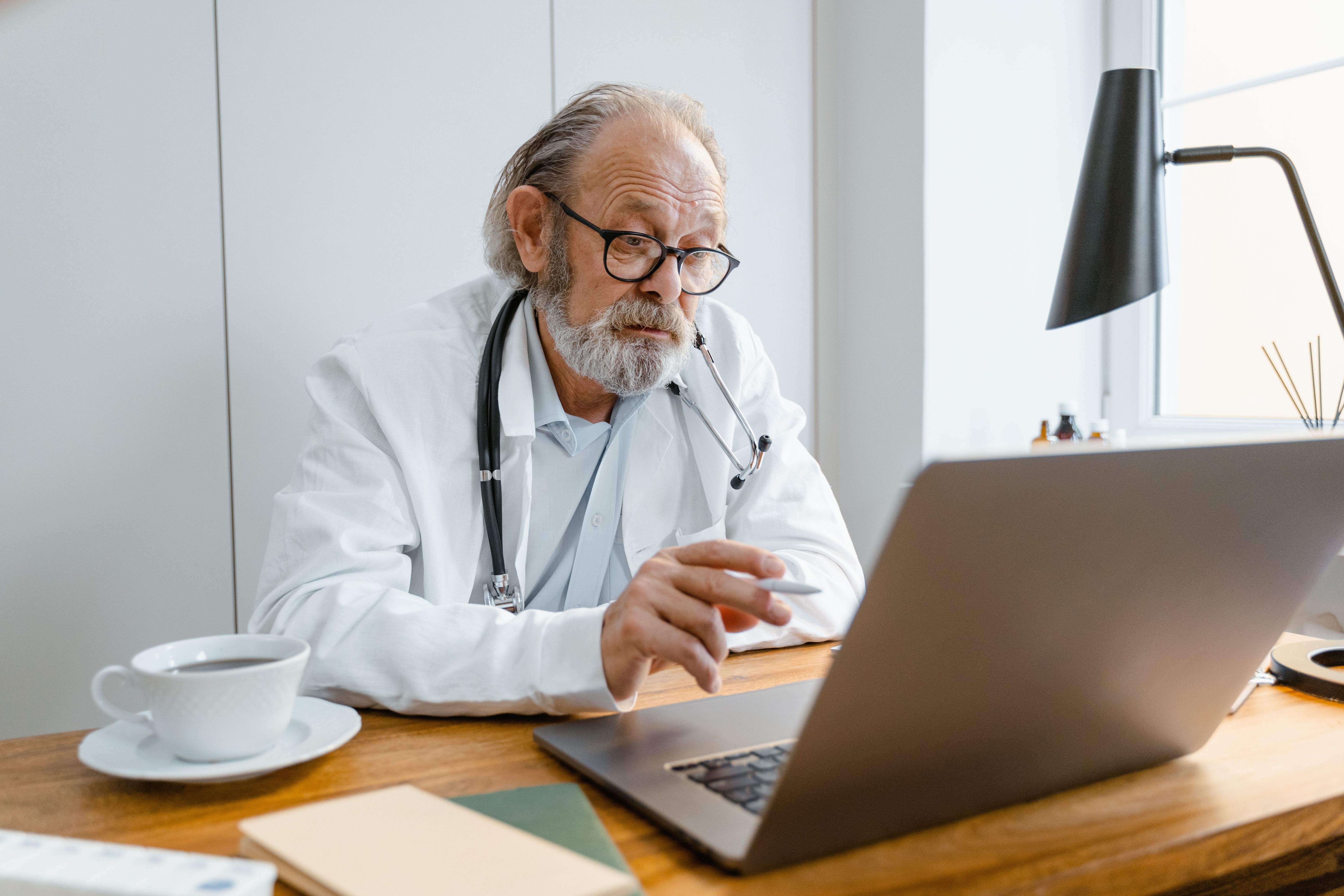 Male doctor offering an online consultation