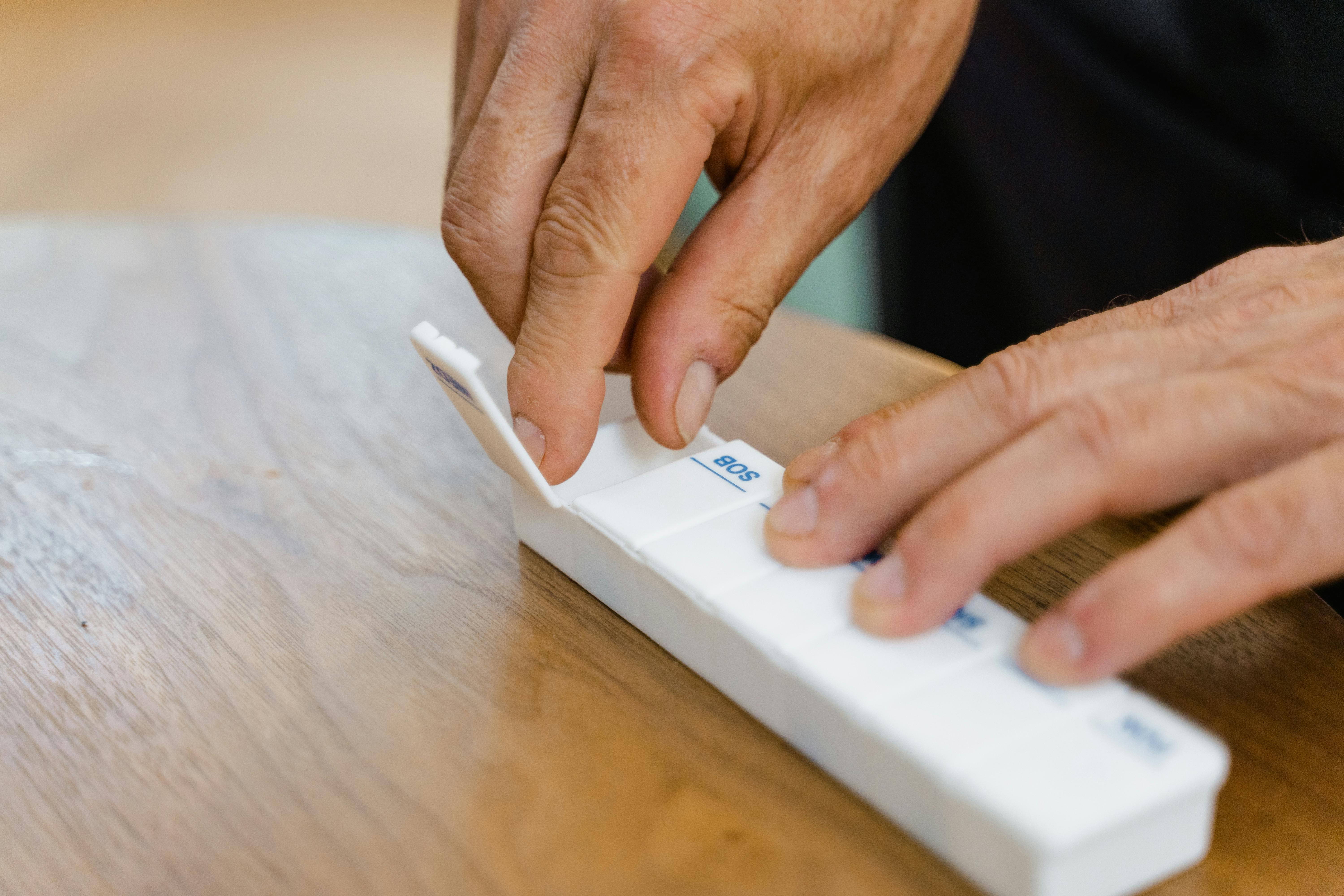 person holding white rectangular box