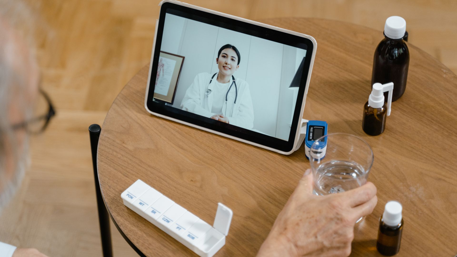Modafinil Telehealth Prescription Online: Accessing Treatment Senior adult having a virtual doctor consultation on a tablet with medications on the table — modafinil telehealth prescription online