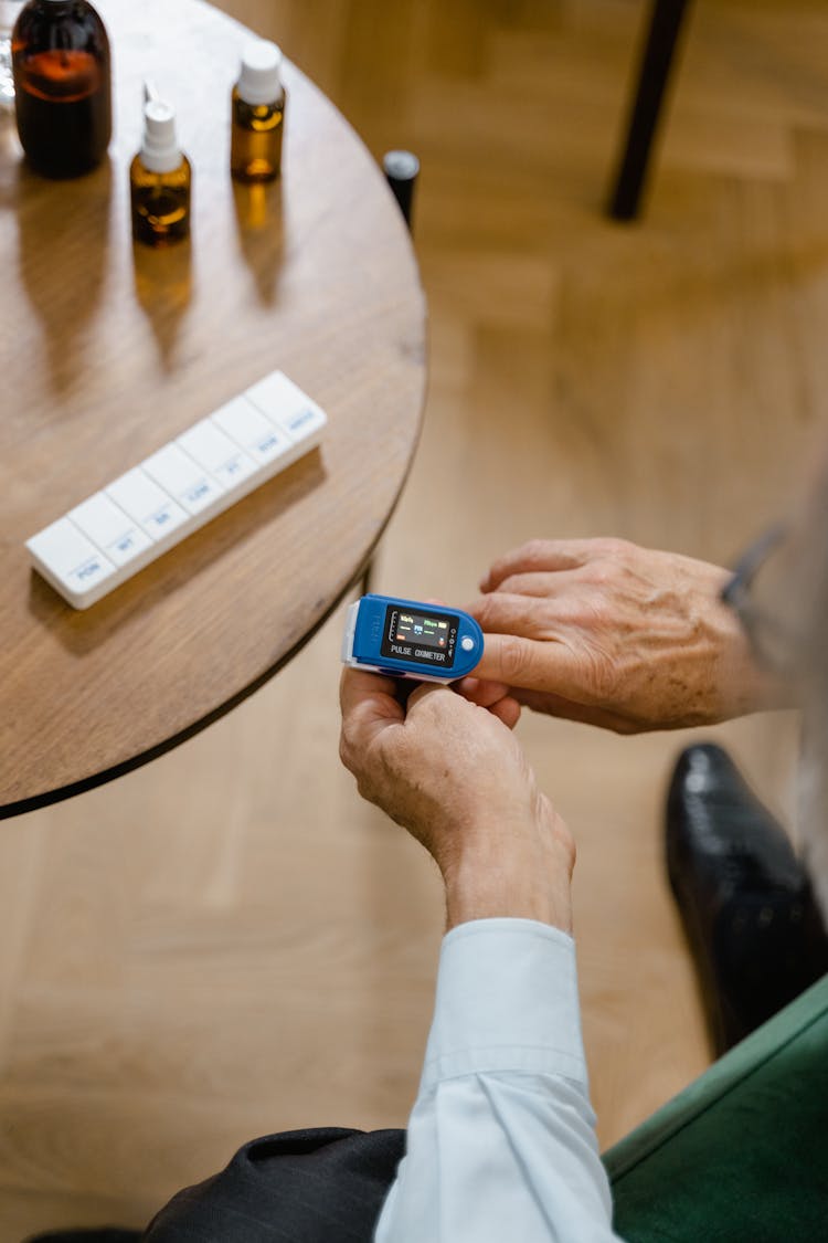 An Elderly Person Checking His Blood Oxygen Level