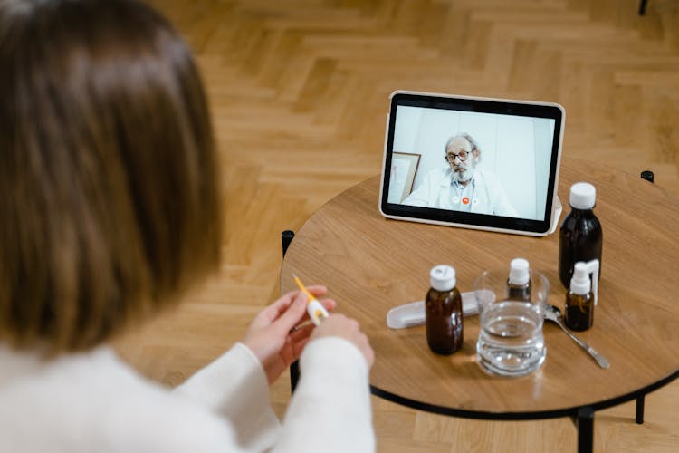 High-Angle Shot Of Two Doctors Making A Zoom Call Using A Tablet Computer