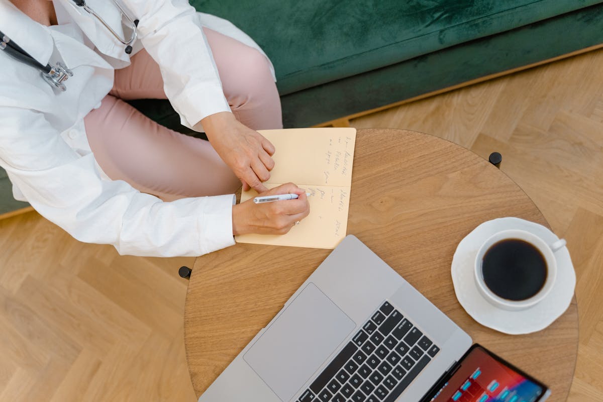 Person writing notes and preparing for their first therapy session