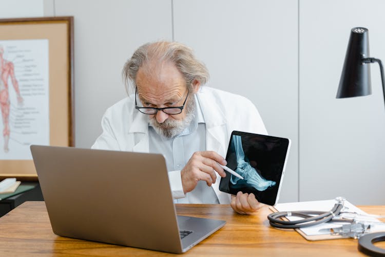 A Doctor Using Laptop