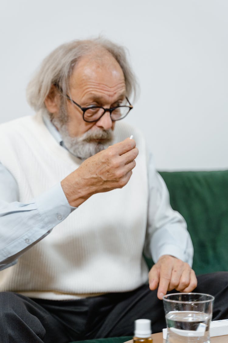 Elderly Man Drinking Medicine