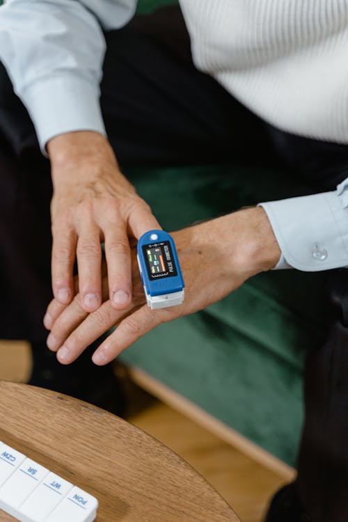 Free A Person Using an Oximeter Stock Photo