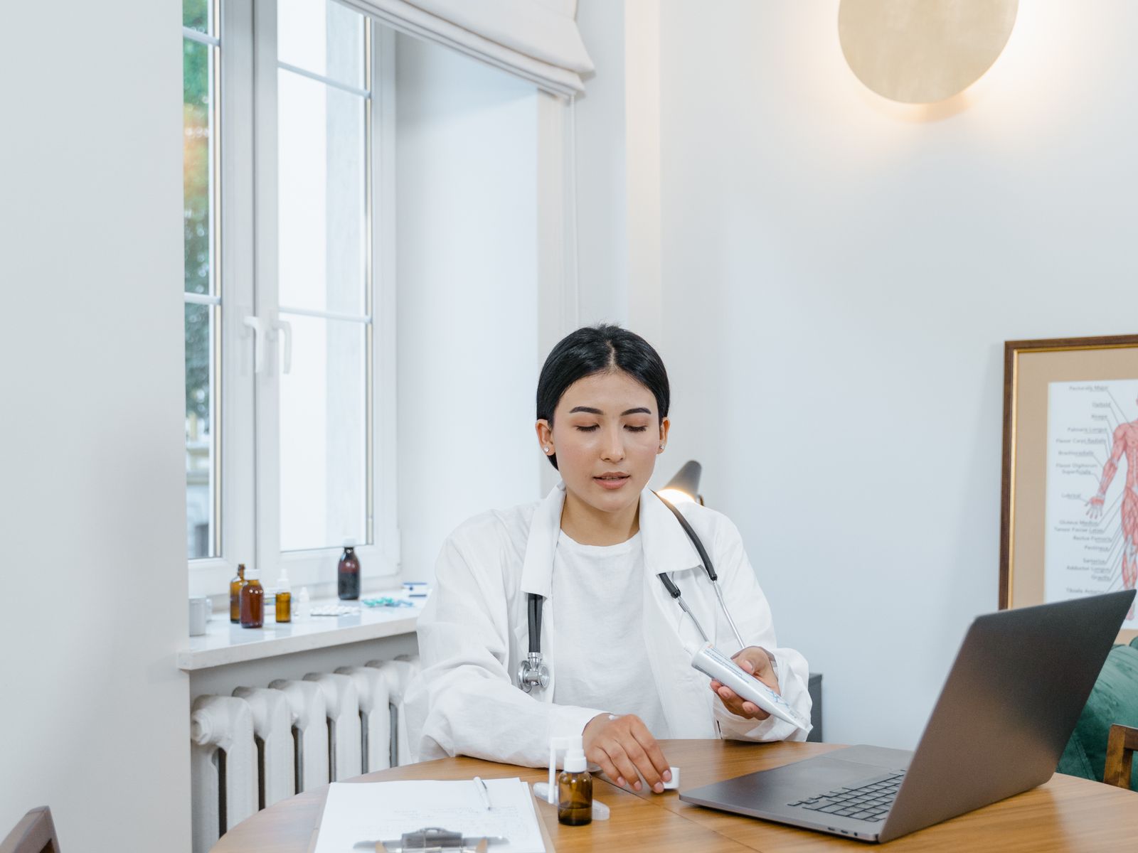 Healthcare professional using a laptop or tablet in a modern practice office