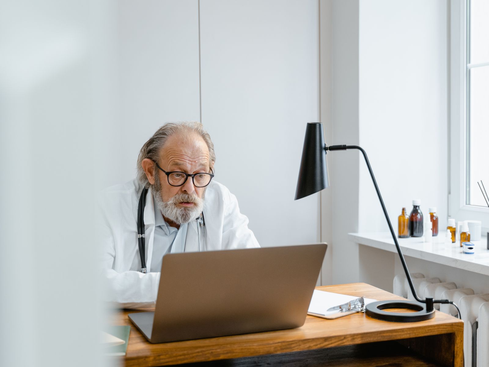 Healthcare professional using a laptop or tablet in a modern practice office