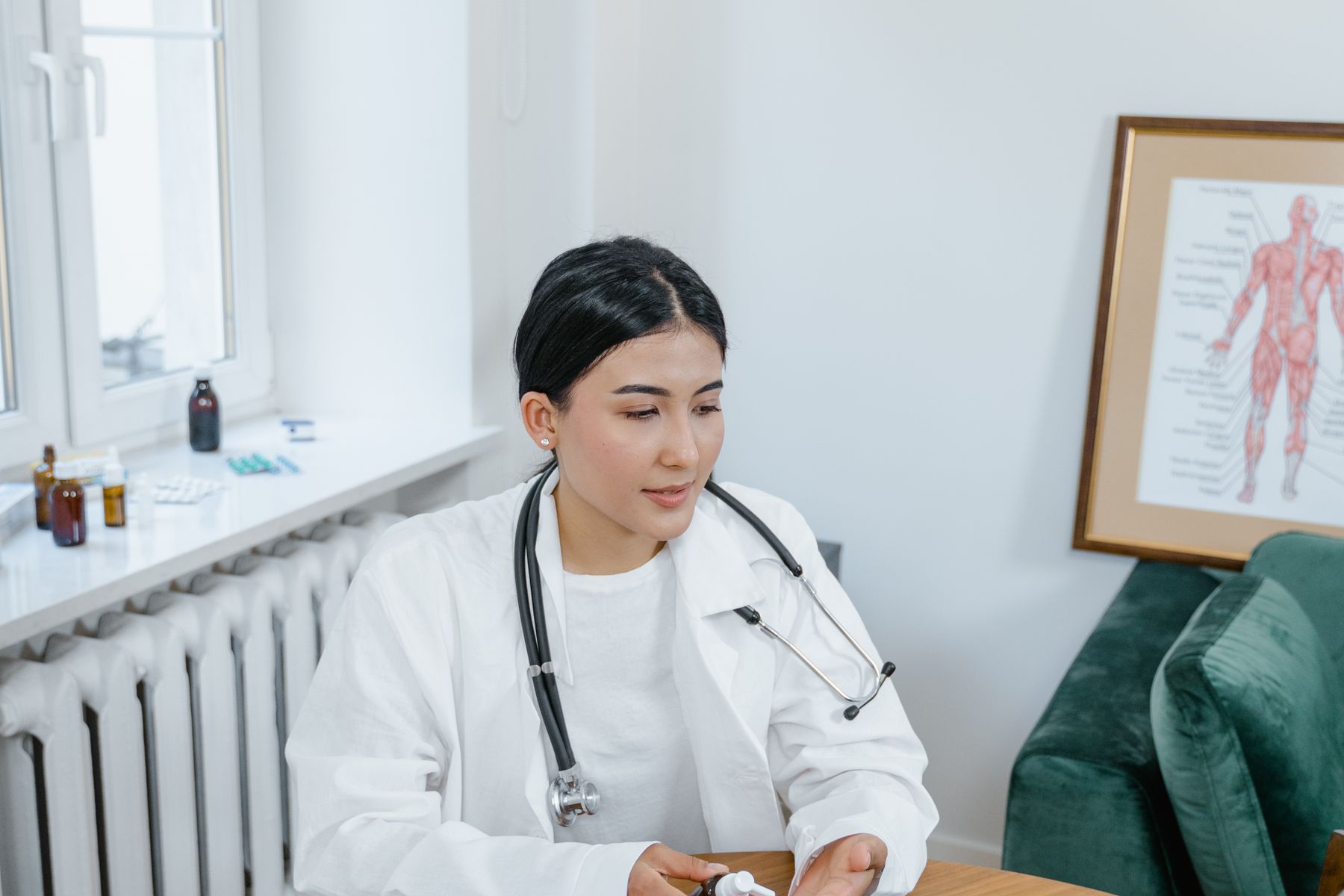 Healthcare professional using a laptop or tablet in a modern practice office