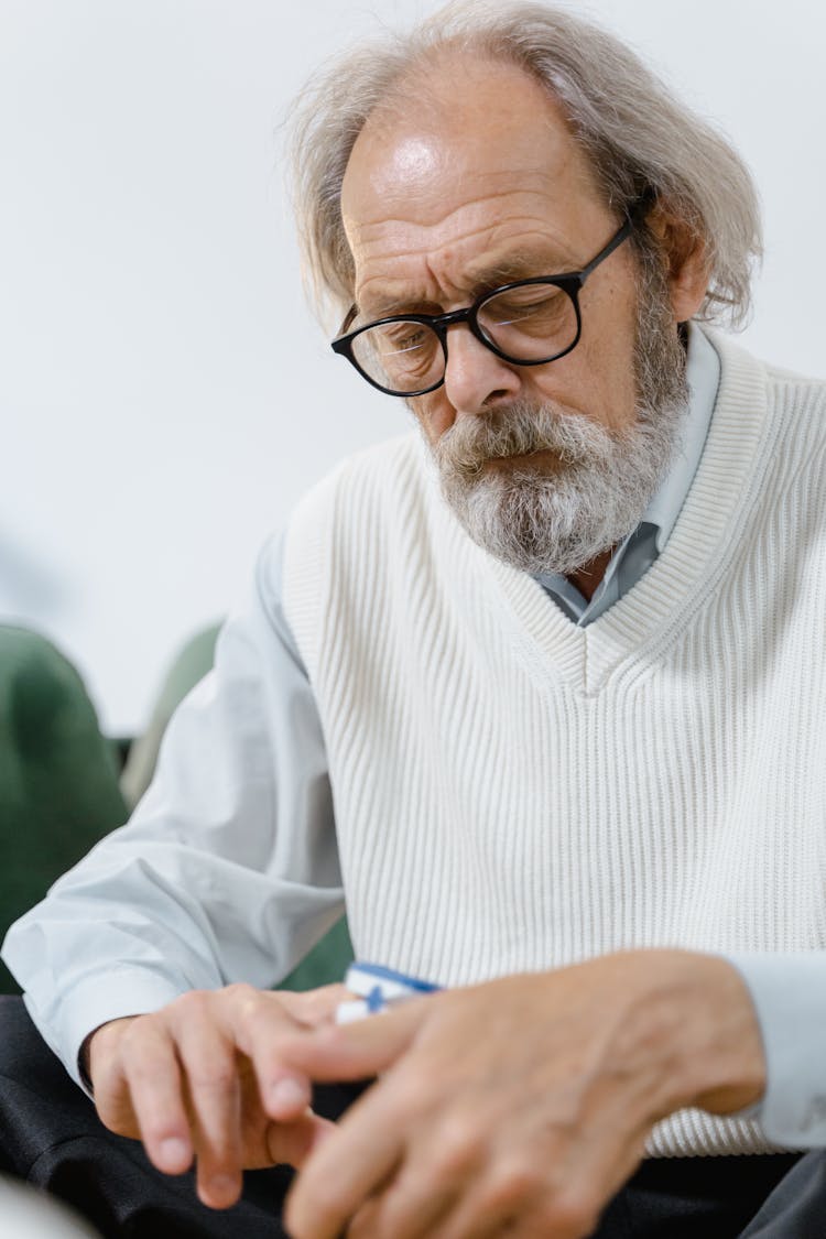 An Elderly Man Measuring His Blood Oxygen