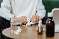 A Person Using a Dosette Box For His Medicine