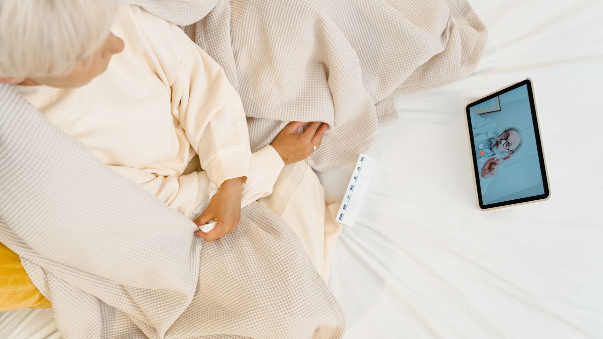 Modafinil Telehealth Prescription Online: Your Ultimate Guide Elderly woman in bed having a video call with a doctor on a tablet, showcasing modern telehealth — modafinil telehealth prescription online