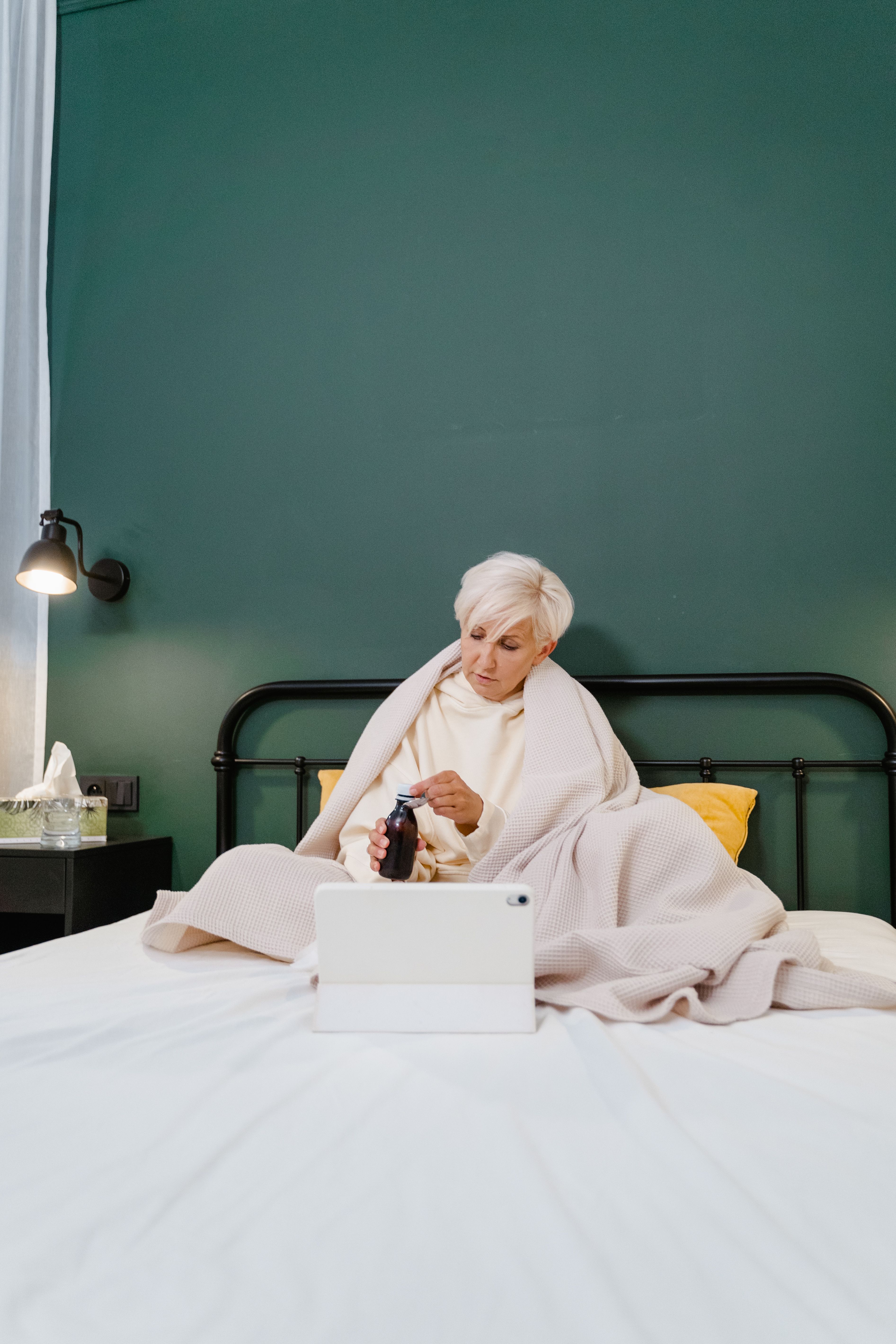 Woman in White Sweater Sitting on Bed · Free Stock Photo