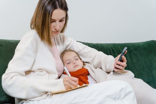 Free A Mother Caring for Her Sick Daughter Stock Photo