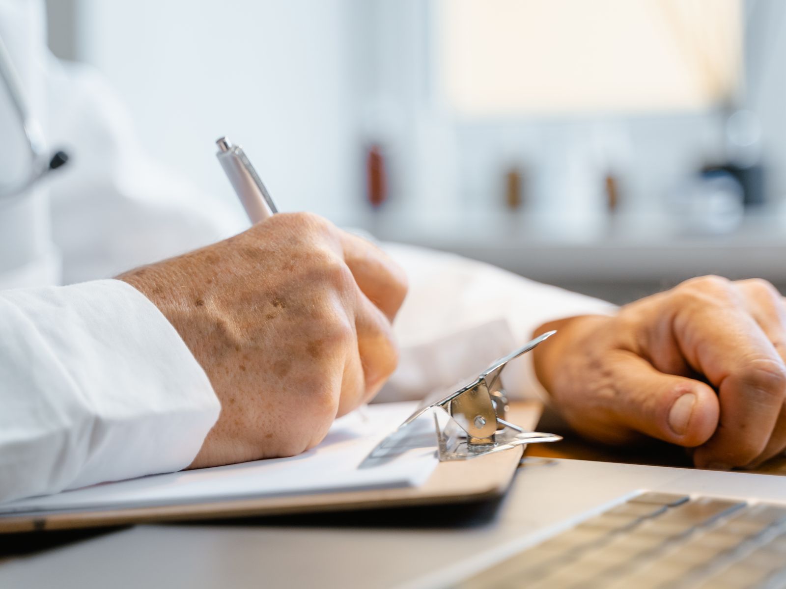 Healthcare professional using a laptop or tablet in a modern practice office