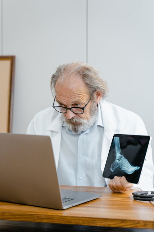 Doctor Holding a Scan of a Foot 