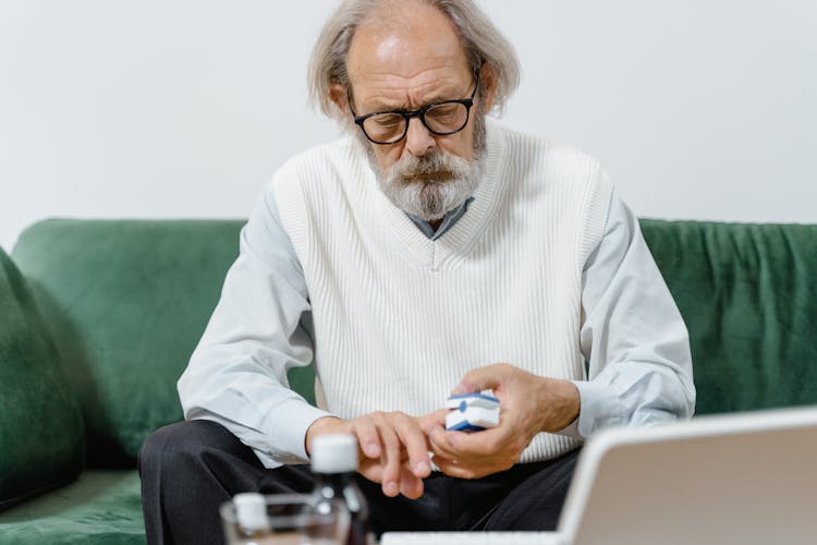 Man Sitting And Cutting Nails