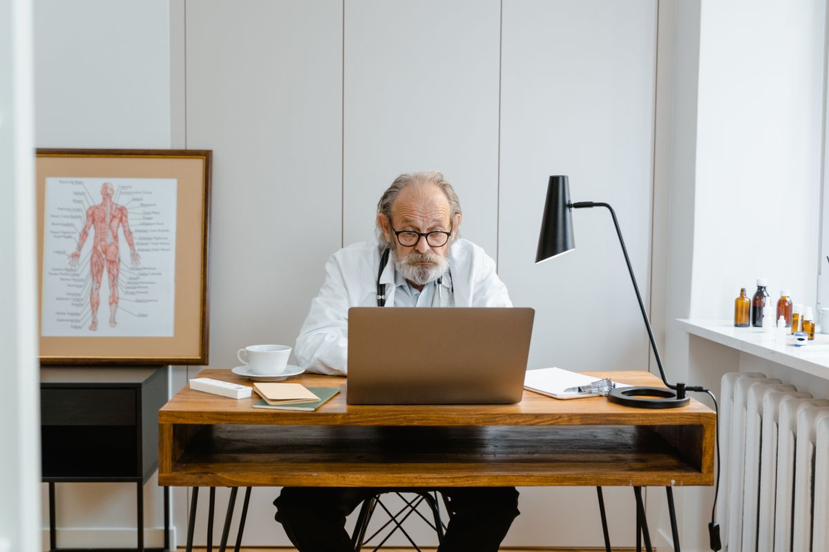 Doctor reviewing information at a desk
