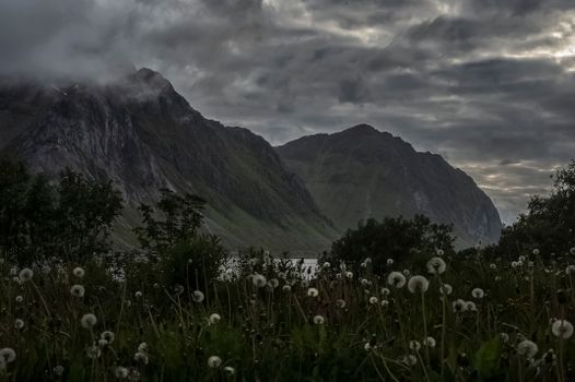 A breathtaking view of rugged mountains under cloudy skies in Nordland, Norway. Perfect for nature lovers.