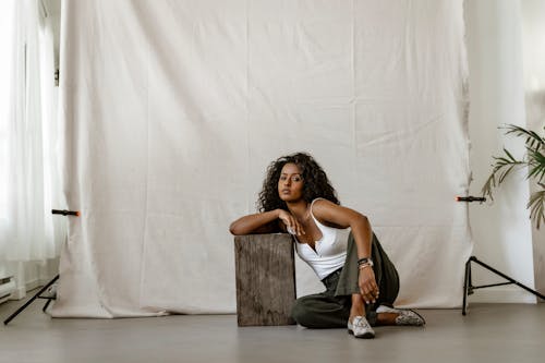 A Woman Posing While Sitting on the Floor