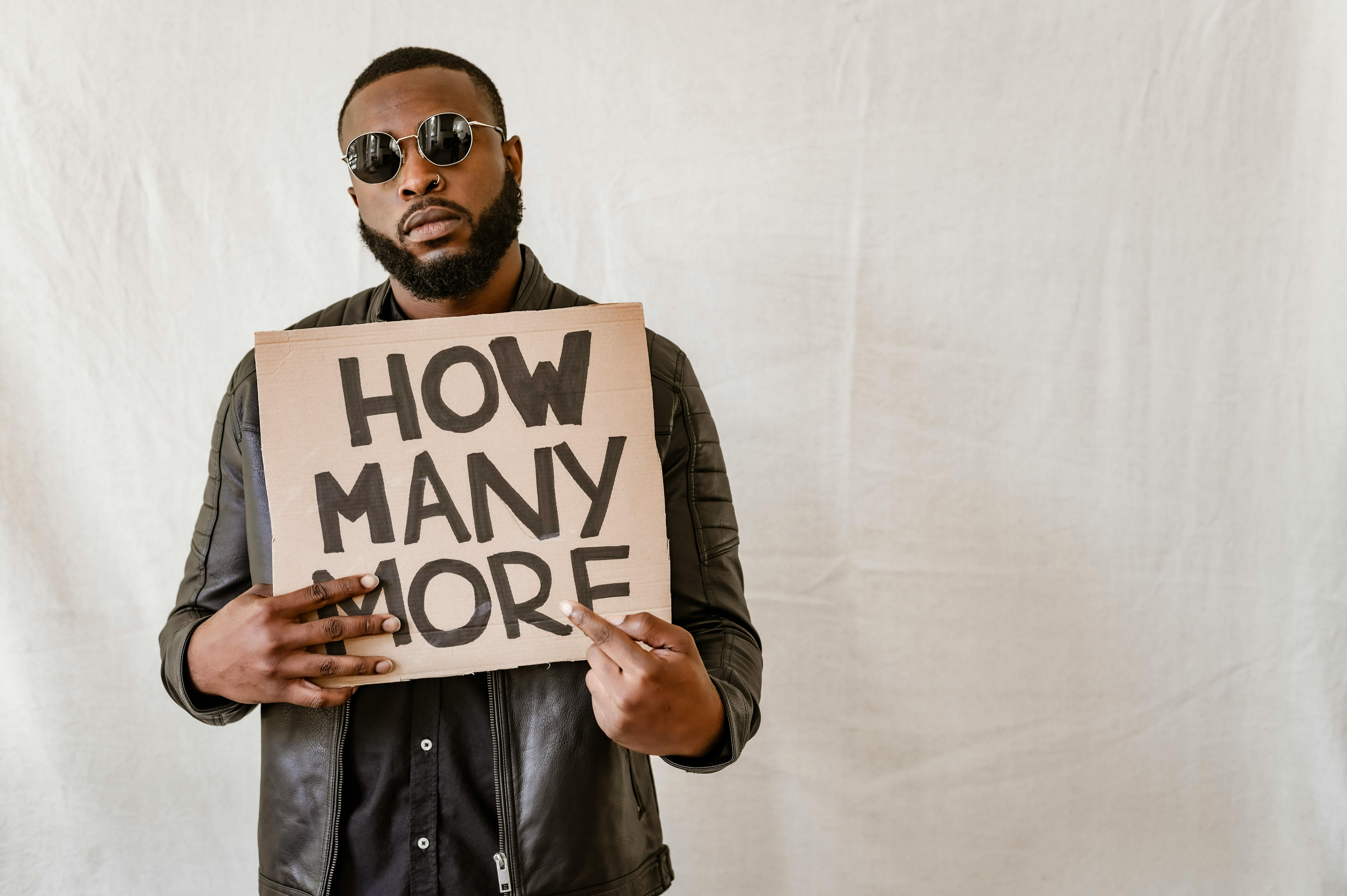 close up shot of a man holding a sign