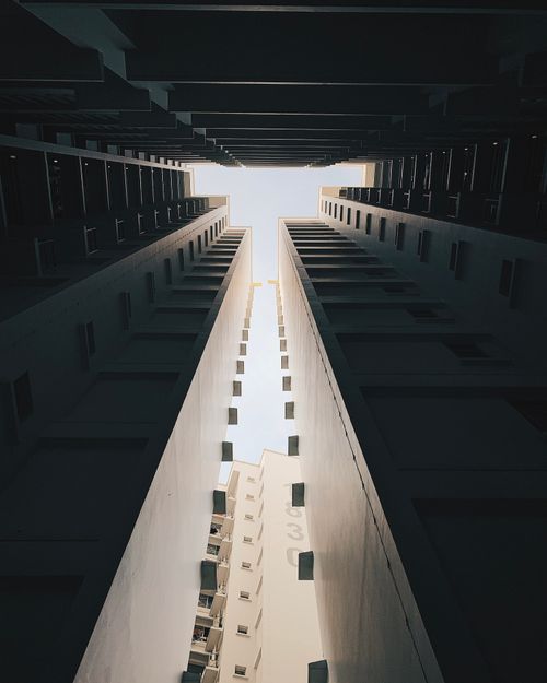 Free A stunning low angle view of high-rise buildings against a clear sky. Stock Photo