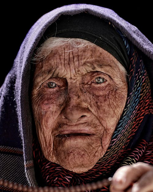 Close-Up Shot of an Elderly Woman Looking at Camera
