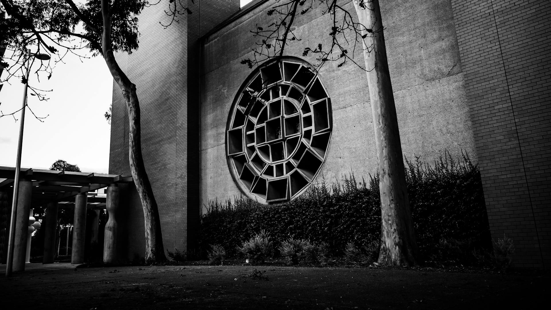 Black and white photo of a building with a distinctive circular window design.