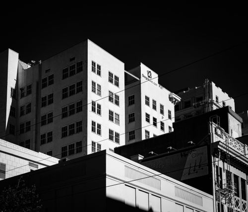 Free Stark monochrome cityscape capturing towering high-rises under deep shadows. Stock Photo