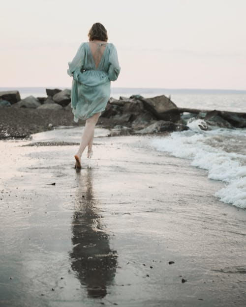 Free Woman Walking on Beach Shore Stock Photo