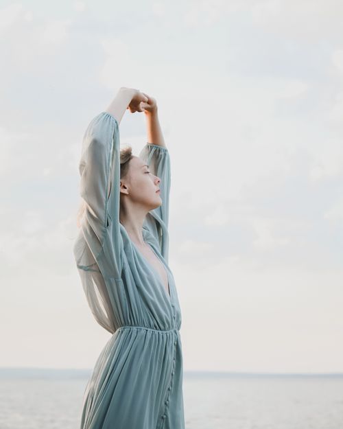 Woman Sitting on a Rock on Seashore · Free Stock Photo