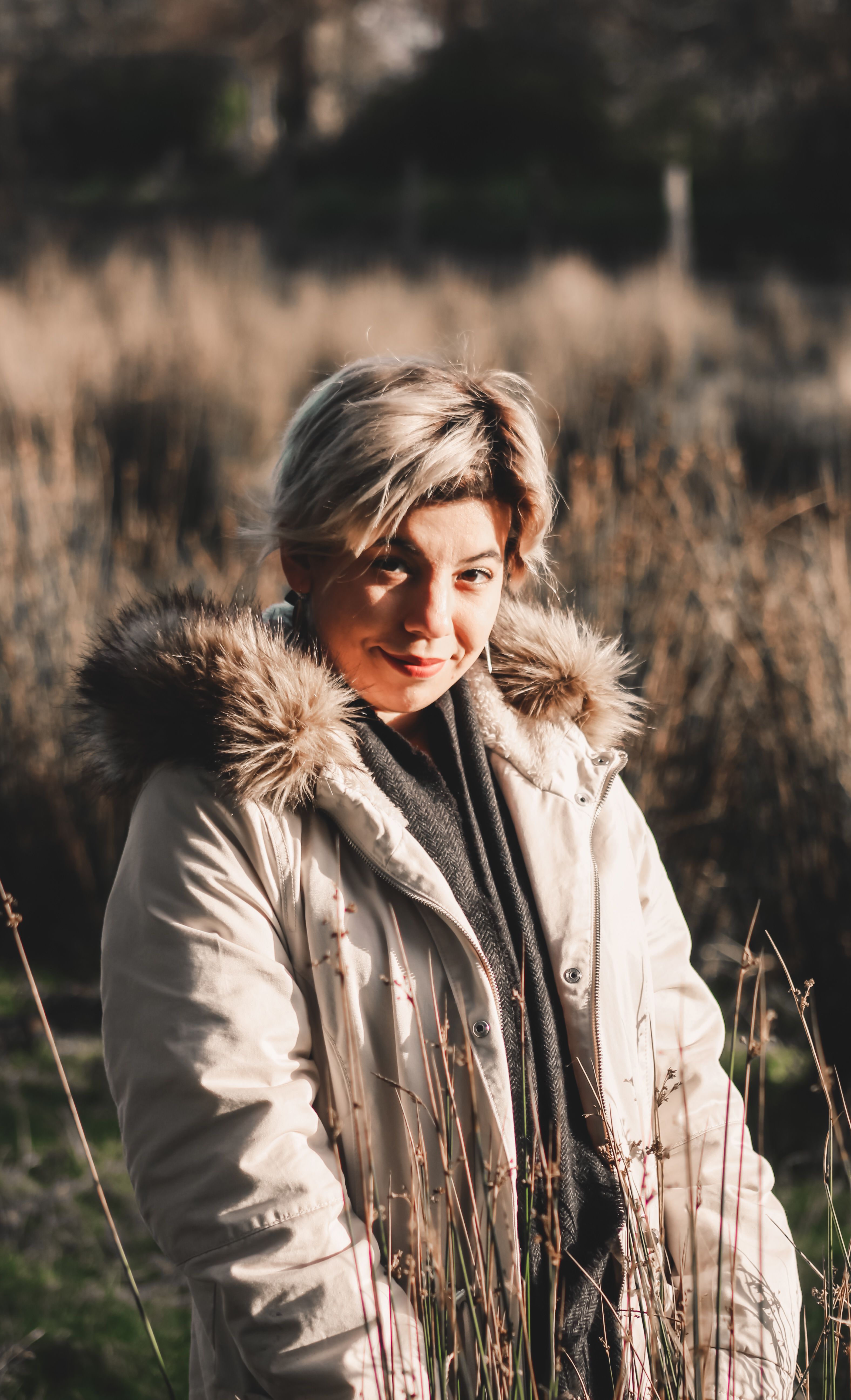 Woman in Beige Jacket Standing on Grass Field · Free Stock Photo