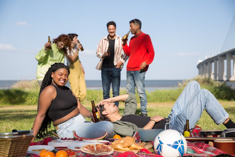 A Group Of People Drinking Beer Together